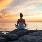 Enhance mental wellness through tranquil meditation by the sea at sunset.
